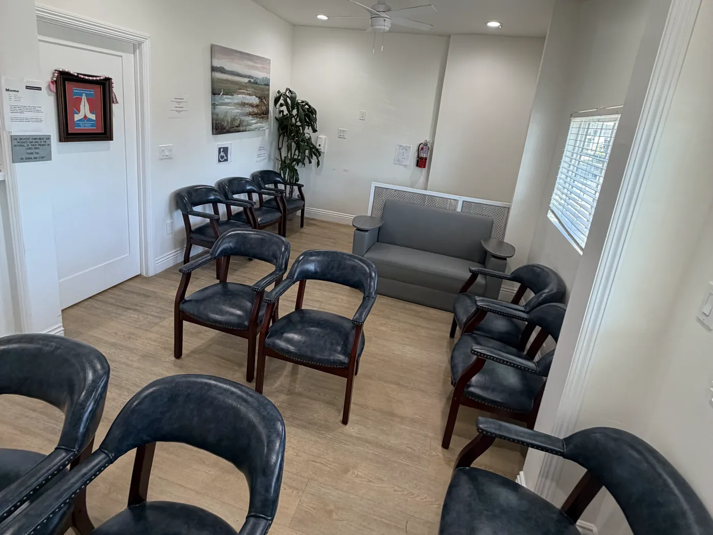 Waiting room at the office: leather armchairs, a sofa, and warm wood floors